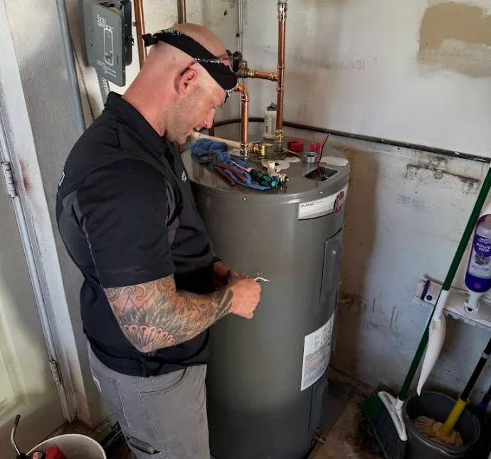 Technician performing water heater installation