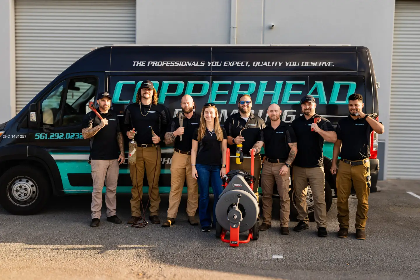 Copperhead Plumbing crew posing with branded service van