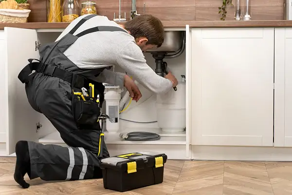 Copperhead plumbing technician fixing under the sink